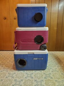 Stack of three coolers converted to cat shelters